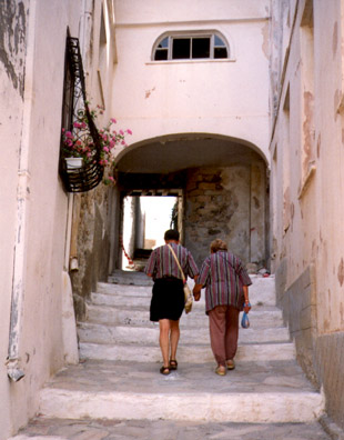 NAXOS: Mimi and Howard climbing steps up a steep street.