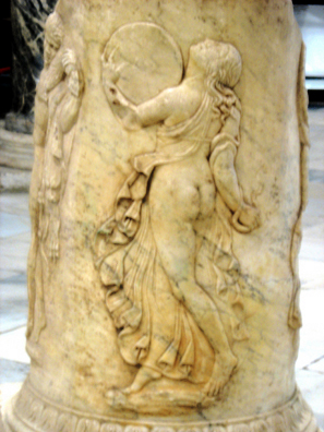 SEVILLA: Carved on a pillar, she dances in Dionysian ecstasy playing a circular drum. In the Sevilla Archaelogical Museum.