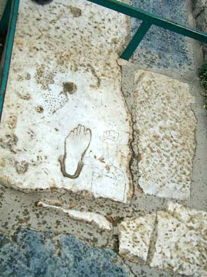 EPHESUS: Paul was amused to find this ad for a prostitute, with the footprint aimed in the direction of her place of business. You can make out a faint but distinctly unflattering portrait of the woman herself on the right.
