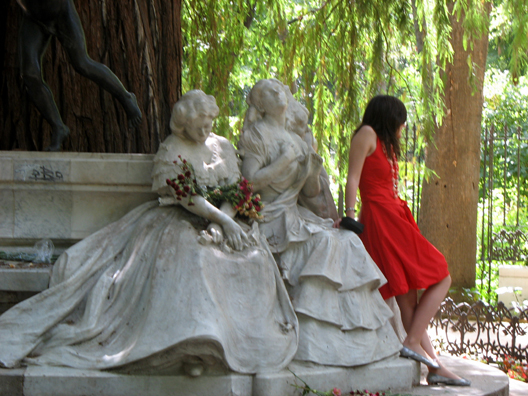 SEVILLA: A young girl poses with the group of mourning female relatives at a sculpture in memory of a Spanish poet in the Parque Maria Luisa, Sevilla.