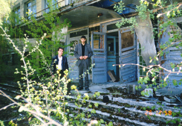 Sasha & a former schoolmate at the entrance to the same school, now abandoned and overgrown. (April, 26 1999)