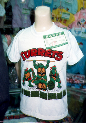 BEIJING: T-shirt in a Beijing department store, with a slightly garbled version of Teenage Mutant Ninja Turtles. May 25: much aimless running around, checking in with United Airlines, visit to very interesting historical museum, loaded with Shang bronzes, great pottery, early printing and books. I rushed through it to have time to pay one final brief visit to the Forbidden City--a long walk to the entrance--but I did get to explore some of its ancillary museums. We had trouble finding a place open for a late lunch, and finally gave up. Most of us were ready to skip a meal after the all the feasting we had done. May 26: up at 5:40 AM for the long trip home: a bus to airport, then flights to Shanghai, Tokyo, San Francisco, and Spokane.