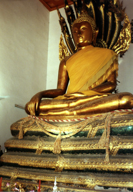 The halo of Nagas (guardian cobras) protecting this Buddha figure are also found frequently in Hindu images of the gods.
