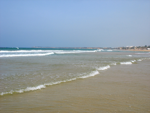 CONIL: The shore slopes gradually here, which means breakers you can wade into, and warm water.