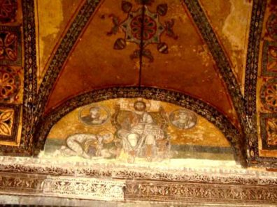 HAGIA SOPHIA: Hagia Sophia also contains several fine Medieval frescos. This image of Christ enthroned is painted in the lunette over the imperial doorway leading into the interior of the church. In the circles on either side are busts Mary and the Archangel Gabriel. The figure on the left is often identified as Leo VI the Wise (886-912) bowing before Christ. Such royal self-portraits were a way of glorifying the Emperor's power and wealth while simultaneously showing his piety, and were common in both the eastern and western churches.