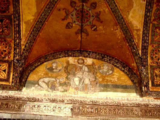 HAGIA SOPHIA: Hagia Sophia also contains several fine Medieval frescos. This image of Christ enthroned is painted in the lunette over the imperial doorway leading into the interior of the church. In the circles on either side are busts Mary and the Archangel Gabriel. The figure on the left is often identified as Leo VI the Wise (886-912) bowing before Christ. Such royal self-portraits were a way of glorifying the Emperor's power and wealth while simultaneously showing his piety, and were common in both the eastern and western churches.