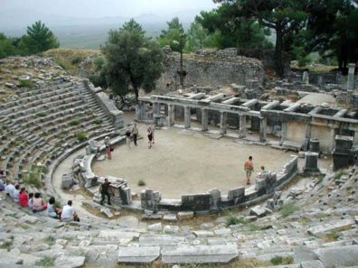 PRIENE: Priene had a small theater. See that rectangular object the guy with his shirt off is walking toward?