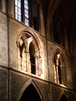 DUBLIN, ST. PATRICK'S CATHEDRAL: During the service, the rays of the setting sun cast colored light through the windows on the stone walls.