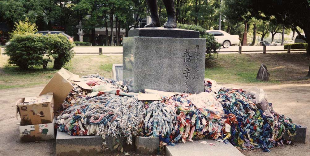 HIROSHIMA: Thousands of folded paper cranes are sent by school children to Hiroshima every day where they are placed on several statues. Here some cartons of them have been rather unceremoniously dumped at the foot of a sculpture of a mother holding her dead children. May 17, 1998