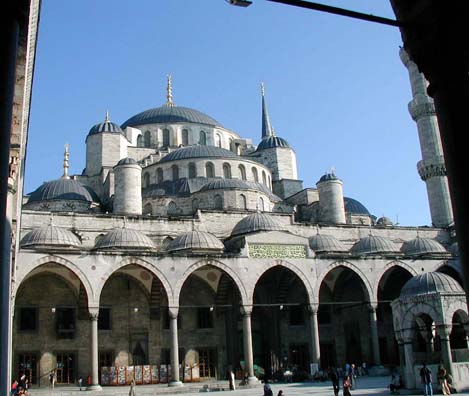 BLUE MASQUE: View from the the gateway through the courtyard to the facade of the mosque itself. On the lower right is the fountain used for ritual cleansing before worship. Non-worshipping tourists are admitted free of charge (as is true of most mosques) outside of times of prayer. The tourist entrance is around the side, in the direction of the minaret in this photo.