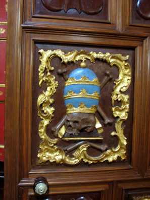 ARCOS DE LA FRONTERA: Detail from church door showing a skull wearing a mitre.
