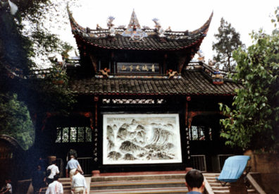 QINGSHEN: Many people were offering prayers, accompanied by a ringing gong. A color TV was playing a soap opera in one corner of the temple. We learned that the bat symbol means happiness.