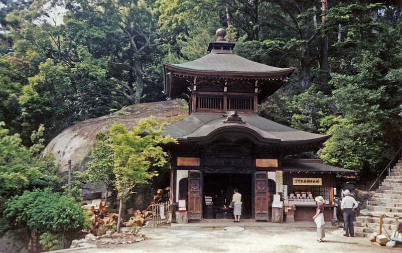 MIYAJIMA: This is the first major temple on the way up Mt. Misen. In it a pot that is reputed to have been boiling steadily ever since the monk Kobo Daishi (774-835) used it to boil his dinner: sort of a variation on the "eternal flame" theme. Note the supply of firewood on the left. He is reputed to have invented the classic Japanese rice paddle, so such paddles are sold throughout the island as souvenirs. May 18, 1998