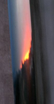 RONDA: Reflection of the sunset in a pipe running down the wall.
