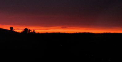 RONDA: Night falls, with just a few specks of light in the dark valley below.
