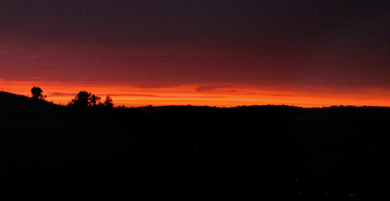 RONDA: Night falls, with just a few specks of light in the dark valley below.