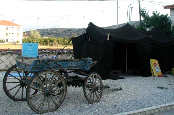 PHASELIS: At another bus stop we spotted this ethnic exhibit: a gypsy cart and traditional tent. Blue plastic seems to be modern equivalent for the migrant workers (mostly women) we saw picking cotton in the fields. Note the ad for Lipton tea.