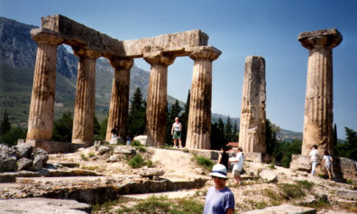 CORINTH: The ancient Doric Temple at Corinth, whose stone is deteriorated much more badly than the Parthenon. Its squat form makes a striking contrast with the latter.