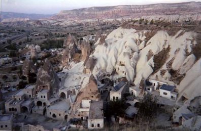 CAPADOCCIA: Capadoccia is famed for its weird geology, much more extensive than the white cliffs of Pamukkale. Deep layers of volcanic ash settled into easily carved tufa which has offered shelter to people creating cave-homes from prehistoric times. During the early Christian era it became a popular retreat for hermits and later for other Christians seeking refuge from persecution by Romans and--later--by Muslims. The heart of this area is the little tourist town of Göreme, where in recent years numerous "cave hotels" have been carved into the rock. There were lots of Christian pilgrims coming here in groups, and even more young people seeking an interesting trip on a budget. There are many real bargains if you shop around. One place was even offering bunkbeds for $3 per night.