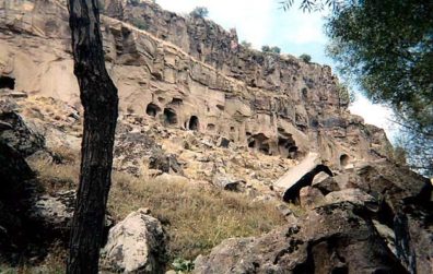 CAPADOCCIA: The valley is pockmarked with monastic retreats, churches, and dovecotes carved into the rock. The former were created to capture droppings, used as fertilizer. Our tour guide took us into only one of the churches, and led a pretty fast pace through the valley. It was obvious why someone might want to hike alone, unguided, though we had a pleasant time and a nice lunch at an outdoor restaurant in the valley where a charming little boy offered Paula a flower for no apparent reason other than he liked her.