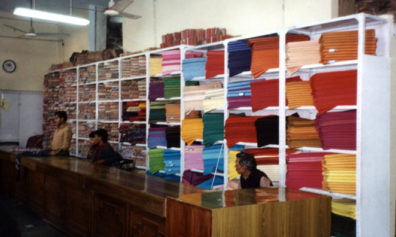The silk department in the famous khadi emporium on Connaught Circus. Khadi is the rough homespun cloth which Gandhi promoted as an alternative to British woven goods during the struggle for independence. His picture was prominently posted in the shop. These fine silks are a different matter entirely, however.
