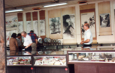 CHENG DU: Shopping in a store specializing in Tibetan curiosities. Many fine shops on this street, selling prayer wheels, gemstones, paintings, and even a ceremonial horn made out of a human femur fitted with silver.