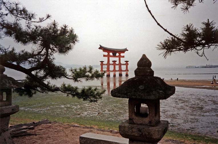 MIYAJIMA: This torii, anchored firmly in the tidal flats just offshore from the Itshukushima Shrine, is a famous symbol of Japan, seen here at sunset, and low tide. May 18, 1998