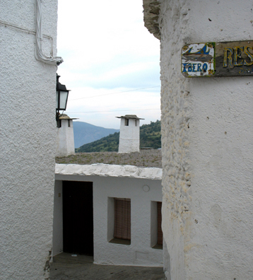 LAS ALPUJARRAS: The sign directs visItors to the wonderful "Ibero" restaurant. Note the capped chimneys typical of this region. They are a local trademark.
