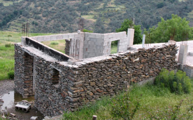 LAS ALPUJARRAS: This unfinished structure shows how modern builders imitate the traditional look of dry stonework by cementing the stones against a poured concrete frame. Unfortunately, the result is a building considerably more vulnerable to the area's frequent earthquakes.