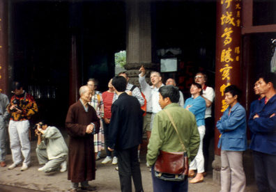TEMPLE OF DIVINE LIGHT: An ancient monk--head of the monastery--greeted us at the entrance and hosted us to green tea and showed us the grounds, including two fragments of the Buddha's ashes in a reliquary, and a huge hall filled with hundreds of carved Buddhas of various designs. He explained the marks burned on his head were meant to remind him that he was like a joss stick, burning in Buddha's honor.
