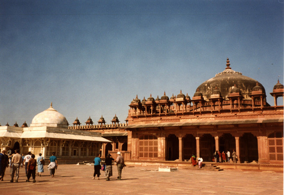 Mausoleum of Sheikh Salim Chishti, built of white marble contrasting with the red sandstone buildings surrounding it. The tomb of this holy man is sought out by women seeking to conceive a child. Fatehpur Sikri was built by the Emperor Akbar as a new capital of the Mughal Empire, but was occupied only from 1570 to 1586.