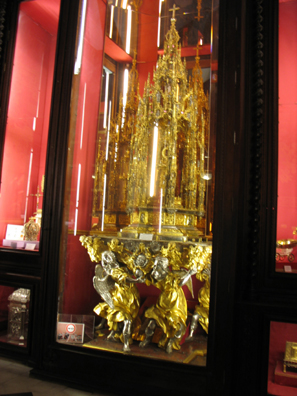 TOLEDO: The 16th-century custodia is a 10" tall portable vehicle meant to display a consecrated host in processions. Although it is sometimes called a "monstrance," the latter is actually the term for a more fixed display not used in processions. This huge, very heavy work made of solid silver covered with gold.