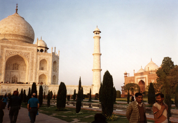 Left, the Taj Mahal, center, a decorative minaret, right: a purely decorative building created as a mirror-image of the mosque to the Taj's left side. The setting sun turns the marble softly golden. 17th C.