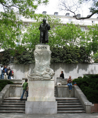 MADRID: Sculpture honoring Spain's most famous painter, Francisco Goya (1746-1828) outside the north entrance of the Prado Museum. At his feet is carved a replica of his famous Maja Desnuda (Naked Maja). Beside him a street musician plays a recorder.