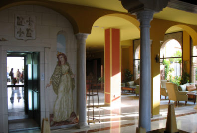CARMONA: The fancifully painted elevator in the lobby contains a mirror which reflects the entrance. The lady in the painting is, of course, the 15th-century queen alluded to in the hotel’s name.