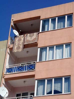 CANAKKALE: Walking around town, we repeatedly saw two objects on the ubiquitous apartment balconies: Turkish carpets and television satellite dishes. Turkey has a large number of satellite systems which serve the role that cable plays in the U.S.