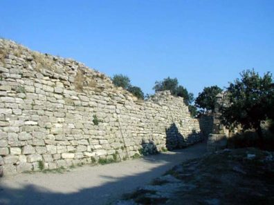 TROY: Some argue that the site was never a true city, but more of a fortress and trading center. Whatever its history, Troy was inhabited from a very early date, and no fewer than nine different levels of construction can be distinguished. You enter the site by these slanted walls--good at withstanding earthquakes--from Troy VI (1700-1250 BCE).