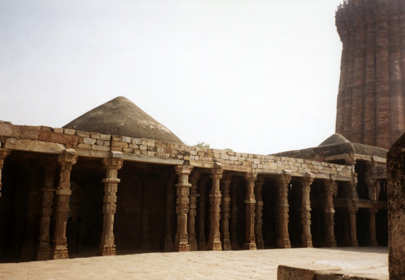 Then our bus proceeded to the Qutub Minar, a gigantic tower of sufficient prominence that distances from Delhi are measured by how far south, north, etc. they are from it. The bottom of the tower is at the right. These domes on the surrounding galleries are supposedly among the most ancient in India.
