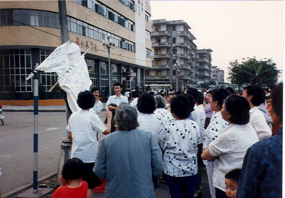LESHAN: Women (and one man) doing group singing on the street . . .