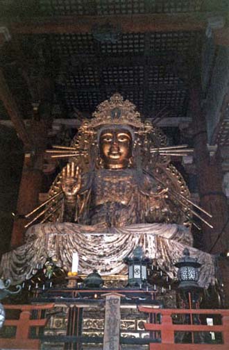 NARA: A smaller image of an incarnation of the Buddha, seated to the left of the famous giant bronze Buddha in the center of the main altar of the Daibutsu Hall. Another such image is on the right side. May 21, 1998