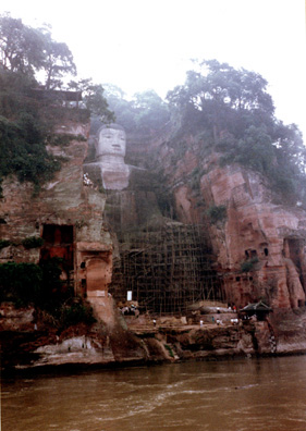 LESHAN: We crossed by boat, then climbed to the top of the cliff behind the Big Buddha. Passing the first display we had seen dedicated to Chairman Mao, Mr. Cai confided to me that he was a Red Guard leader while in middle school, during the Cultural Revolution. "It was a lot more fun than studying!" He added later that a whole generation had been lost to the movement, with many talented people failing to get the educations they needed to succeed in careers. This was the biggest Buddha in the world until a businessman build a bigger one in Japan in modern times. It was badly corroded, perhaps from air pollution. The scaffolding had been erected for restoration purposes.
