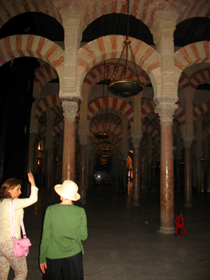 CORDOBA: A guide talks with Paula Elliot out a tour of the mosque. Because of the cathedral which blocks its center, few photographs show the full width of the mosque, but this shot suggests the building's size.