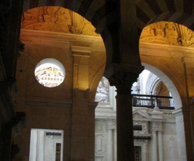CORDOBA: In 1523 a Christian cathedral was built right in the center of the old mosque, destroying forever the original effect of the vast hall of pillars. But the fact that the structure was the city cathedral may have helped preserve it in the following centuries. Here, a view from the Muslim into the Christian portions of the building.