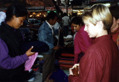 Megan Brians buys a shawl from a street vendor whose features reflect her probable origins in the Himalayas.