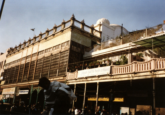 On the morning of December 28, we were welcomed at the national Ethnomusicalogical Archives by Shubha Chaudari, with whom I had been corresponding thanks to the introduction of Laurel Sercombe, our Seattle ethnomusicology friend. While Paul Smith viewed field recordings of been performers (he had ordered one of the instruments made for him and ended by buying three), Megan and I viewed the first part of an excellent documentary about the traditional temple dancers of India. Unfortunately, our visit was ended by a power outage, and Shubha kindly sent us back to our hotel in the Institute's jeep. Our entire family jammed into a bicycle rickshaw propelled by a very hard-working but seemingly fit young man for an hour's tour of Old Delhi. The ancient walled city is a Muslim enclave many of whose inhabitants seldom venture out; but it is also the center for the publishing industry. Most of the storefronts are relatively modern, but shuttered balconies like these are not rare. They look very much like similar balconies in the Middle East.