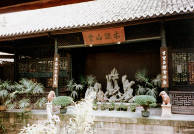 THREE SUS: Shrine featuring ornate rocks.