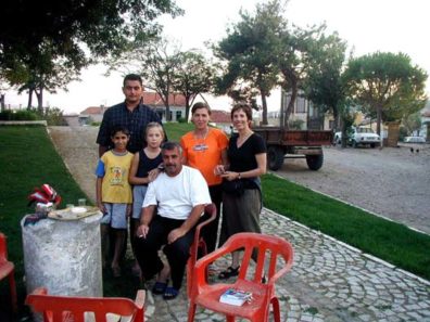 BERGAMA: While we were walking around old Ulu, the little girl in this picture said "Hello, Hello," as many kids will when they see tourists; but she was unusual in being willing to actually have a conversation. She was in the park with her parents, Mr. and Mrs. Demirer, who had put their evening tea tray down on an antique column in front of their house and were enjoying the evening air with the children. Although we could only piece together fragments of Turkish with a phrase book and only the little girl spoke any English, they invited us to join them for tea, and we spent a delightful twenty minutes visiting with gestures, smiles, and occasional words that made sense to both sides. It was one of the nicest experiences of our trip.