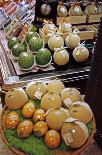 Expensive melons, lavishly presented. Japan is the land of excess packaging. In a bakery, each roll is separately wrapped, then the whole put in a plastic bag. Buy a carton of juice and that gets its own bag too. May 22, 1998