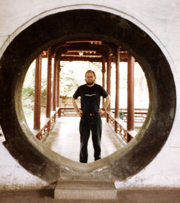 THREE SUS: Paul in a circular doorway.