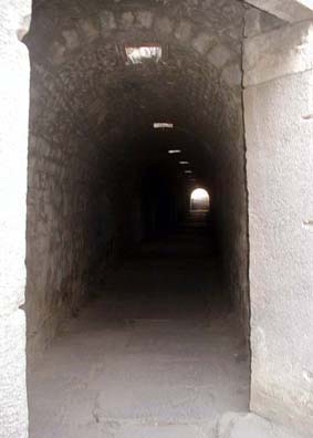ASCLEPION: The corridor is a classic Roman vaulted tunnel...